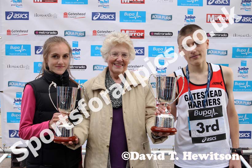 Mrs. Joan Long presents the Stan Long Memorial Trophy to Lydia Turner (Birtley) and Jed Marshall (Gateshead) at the BUPA  Great North Junior Great Run .